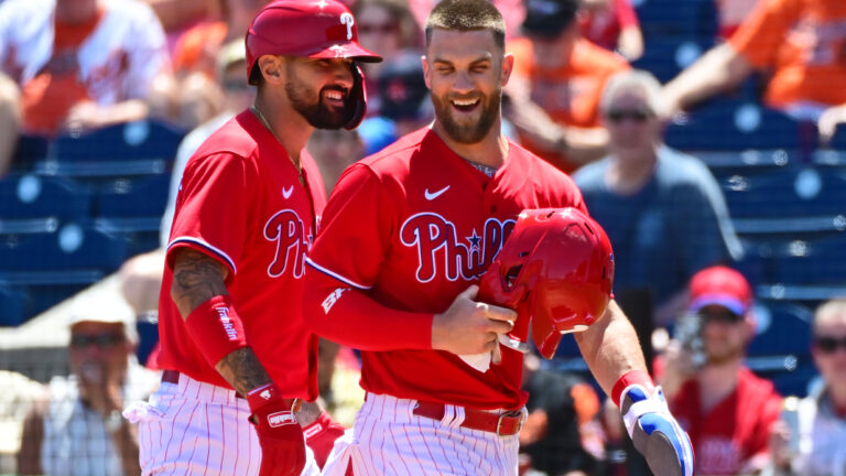Nick Castellanos and Bryce Harper of the Philadelphia Phillies react after Castellanos hit a two-run home run in the first inning against the Baltimore Orioles during the spring training game at BayCare Ballpark.