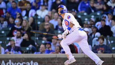Seiya Suzuki of the Chicago Cubs hits a home run in the seventh inning against the Cincinnati Reds at Wrigley Field.