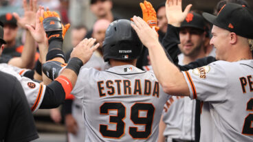 Thairo Estrada of the San Francisco Giants celebrates his first inning home run with teammates while playing the Detroit Tigers.