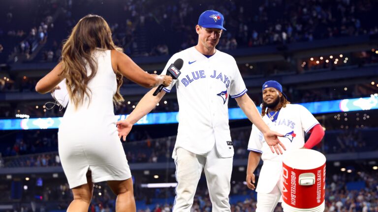 Chris Bassitt of the Toronto Blue Jays is doused with water by Vladimir Guerrero Jr. #27 after throwing a complete game against the Atlanta Braves at Rogers Centre.