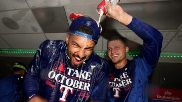 Marcus Semien and Corey Seager of the Texas Rangers celebrate in the clubhouse after the Texas Rangers clinched a 2023 MLB playoff berth Mariners at T-Mobile Park.