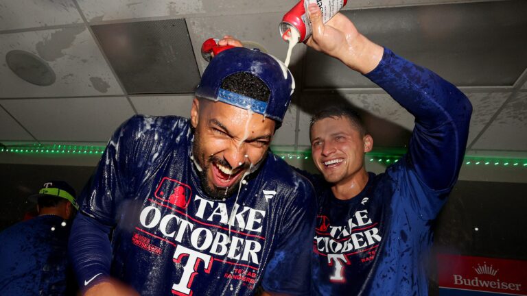 Marcus Semien and Corey Seager of the Texas Rangers celebrate in the clubhouse after the Texas Rangers clinched a 2023 MLB playoff berth Mariners at T-Mobile Park.