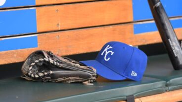 DETROIT, MI - SEPTEMBER 29: A detailed view of a Kansas City Royals baseball hat and glove sitting in the dugout during the game against the Detroit Tigers at Comerica Park on September 29, 2022 in Detroit, Michigan. The Tigers defeated the Royals 10-3. (Photo by Mark Cunningham/MLB Photos via Getty Images)