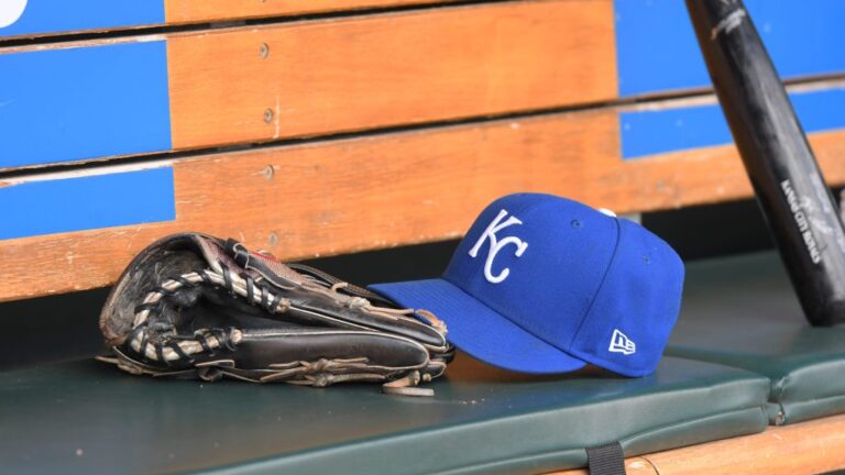 DETROIT, MI - SEPTEMBER 29: A detailed view of a Kansas City Royals baseball hat and glove sitting in the dugout during the game against the Detroit Tigers at Comerica Park on September 29, 2022 in Detroit, Michigan. The Tigers defeated the Royals 10-3. (Photo by Mark Cunningham/MLB Photos via Getty Images)