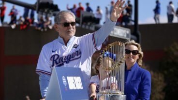 ARLINGTON, TEXAS - NOVEMBER 03: Texas Rangers manager Bruce Bochy and his wife Kim Seib ridie with the World Series trophy and wave to fans lining the street and buildings during the World Series Victory Parade outside Globe Life Field on November 3, 2023 in Arlington, Texas. The Rangers defeated the Arizona Diamondbacks, 4-1 at the World Series. (Photo by Tom Fox - Pool/Getty Images)