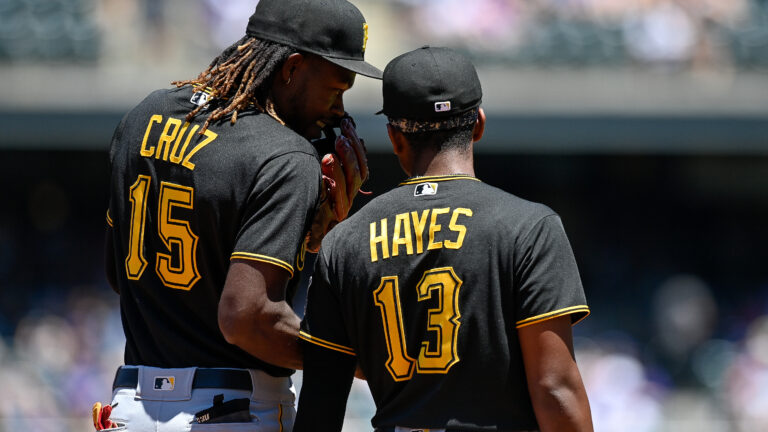 Pittsburgh Pirates shortstop Oneil Cruz (15) has a word with third baseman Ke'Bryan Hayes (13) during a game between the Pittsburgh Pirates and the Colorado Rockies at Coors Field.