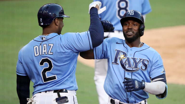 Randy Arozarena #56 of the Tampa Bay Rays is congratulated by Yandy Diaz #2 after hitting a solo home run against the Houston Astros during the fourth inning in game one of the American League Championship Series at PETCO Park.