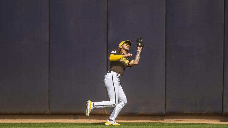 Jackson Merrill of the San Diego Padres makes a catch in center field during a Spring Training game against the Kansas City Royals at the Peoria Stadium.