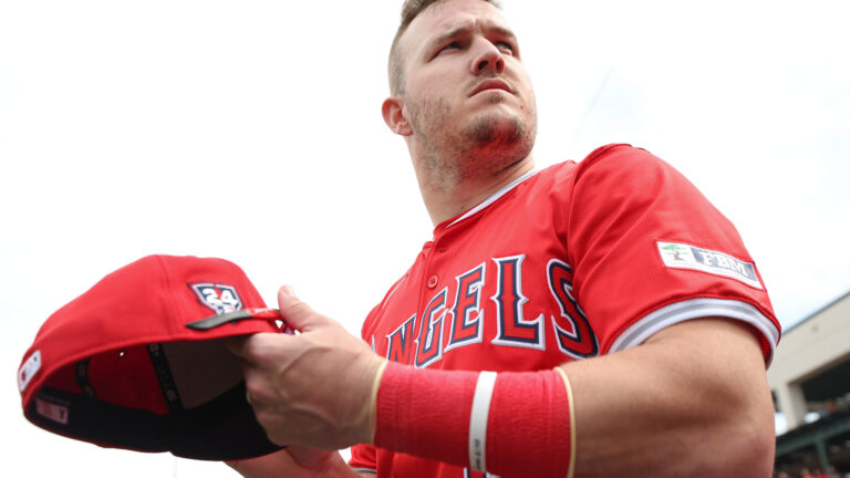 Mike Trout #27 of the Los Angeles Angels looks on during a spring training exhibition against the Los Angeles Dodgers at the Peoria Sports Complex.