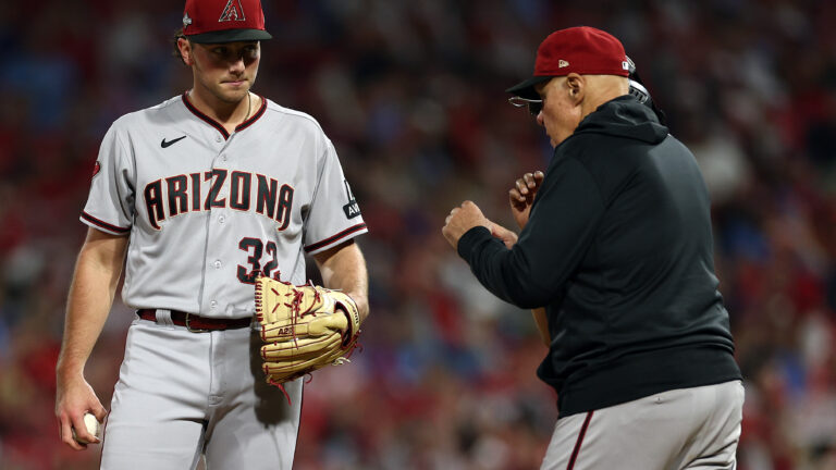 Brandon Pfaadt of the Arizona Diamondbacks reacts as pitching coach Brent Strom #72 talks with him against the Philadelphia Phillies during the fourth inning in Game Seven of the Championship Series at Citizens Bank Park.