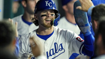 Bobby Witt Jr. of the Kansas City Royals is congratulated by teammates after scoring a run during the fifth inning against the Houston Astros at Kauffman Stadium.