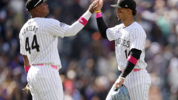 Elehuris Montero #44 and Ezequiel Tover #14 of the Colorado Rockies