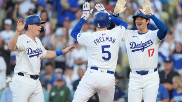 Freddie Freeman #5 of the Los Angeles Dodgers celebrates with teammates Shohei Ohtani #17 and Will Smith #16 after hitting a three run home run against the Arizona Diamondbacks during the first inning at Dodger Stadium.