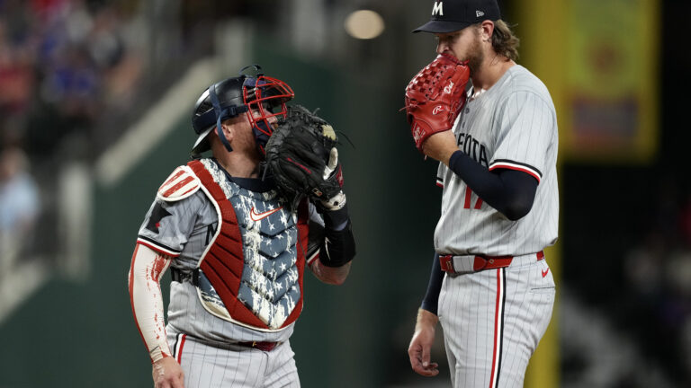 Christian Vázquez and Bailey Ober of the Minnesota Twins talk on the mound during the fourth inning against the Texas Rangers at Globe Life Field.
