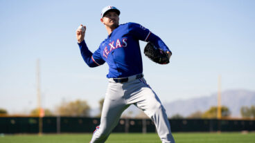 Tyler Mahle of the Texas Rangers warms up during a spring training workout at Surprise Stadium.