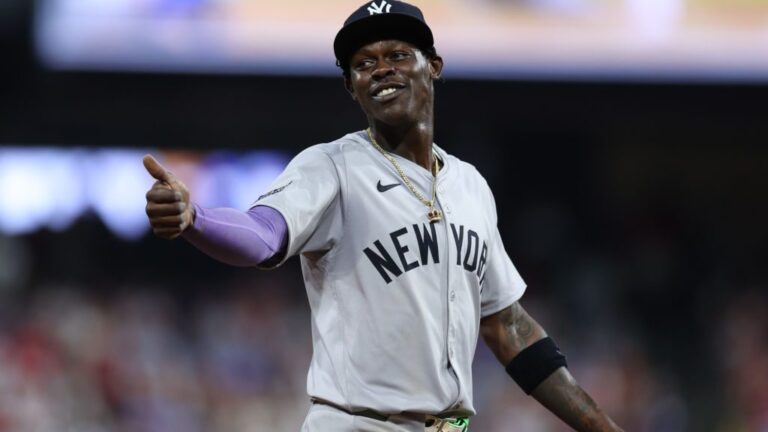 Jazz Chisholm Jr. of the New York Yankees smiles to a fan during the ninth inning against the Philadelphia Phillies at Citizens Bank Park in Philadelphia, Pennsylvania.