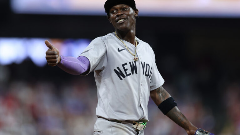 Jazz Chisholm Jr. of the New York Yankees smiles to a fan during the ninth inning against the Philadelphia Phillies at Citizens Bank Park in Philadelphia, Pennsylvania.