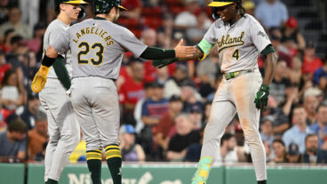 Breakout star Lawrence Butler of the Oakland Athletics celebrates with Shea Langeliers #23 and Zack Gelof #20 after hitting a three-run home run.