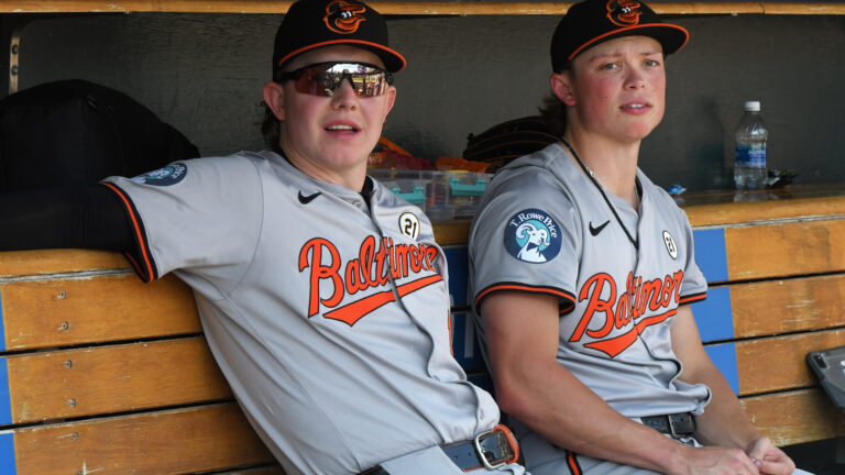 Heston Kjerstad and Jackson Holliday of the Baltimore Orioles look on from the dugout during the game against the Detroit Tigers at Comerica Park.