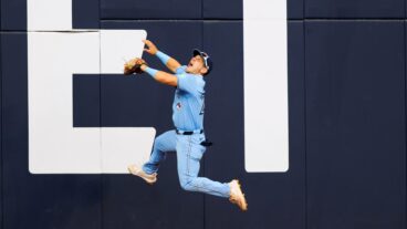 Daulton Varsho of the Toronto Blue Jays leaps but can't catch a home run off the bat of Taylor Ward #3 of the Los Angeles Angels in the ninth inning of their MLB game against the Los Angeles Angels at Rogers Centre.