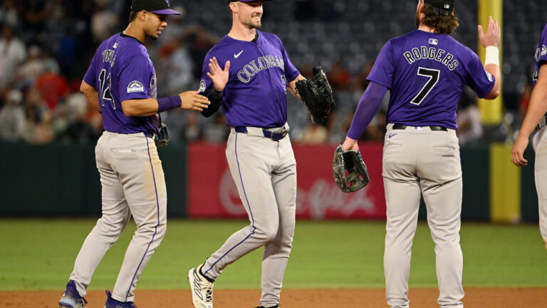 ANAHEIM, CA - JULY 31: Colorado Rockies center fielder Brenton Doyle (9) celebrates with his teammates on the field after the Rockies defeated the Los Angeles Angels 2 to 1 in an MLB baseball game played on July 31, 2024 at Angel Stadium in Anaheim, CA. (Photo by John Cordes/Icon Sportswire via Getty Images)