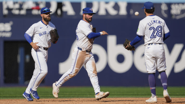 TORONTO, ON - SEPTEMBER 15: Davis Schneider #36, Nathan Lukes #38, and Ernie Clement #28 of the Toronto Blue Jays celebrate defeating the St. Louis Cardinals in their MLB game at the Rogers Centre on September 15, 2024 in Toronto, Ontario, Canada. (Photo by Mark Blinch/Getty Images)