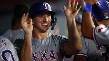 Wyatt Langford of the Texas Rangers celebrates runs scored with teammates in the dugout in during the ninth inning against the Los Angeles Angels at Angel Stadium of Anaheim.