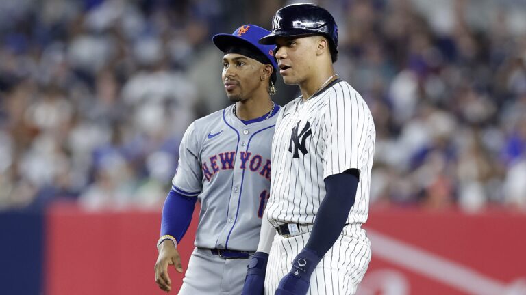 Juan Soto #22 of the New York Yankees stands at second base with Francisco Lindor #12 of the New York Mets during the fifth inning of their game at Yankee Stadium.