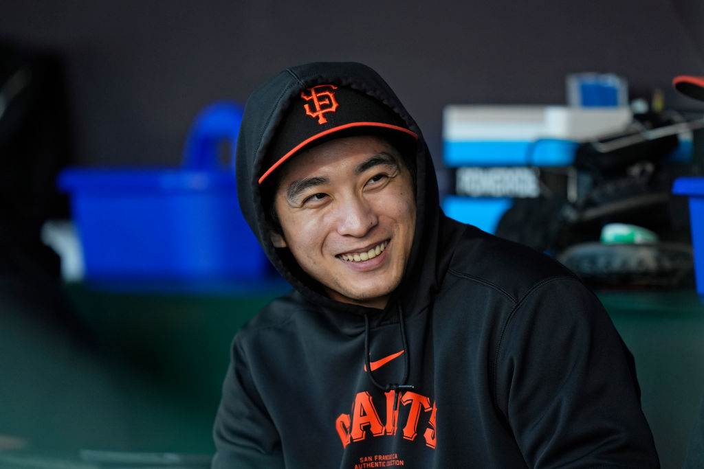 Jung Hoo Lee of the San Francisco Giants watches the game from the dugout at Oracle Park.