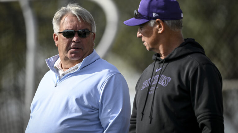 Colorado Rockies general manager Bill Schmidt and manager Bud Black watch outfielders and infielders perform drills during Spring Training at Salt River Fields in Scottsdale, Arizona.