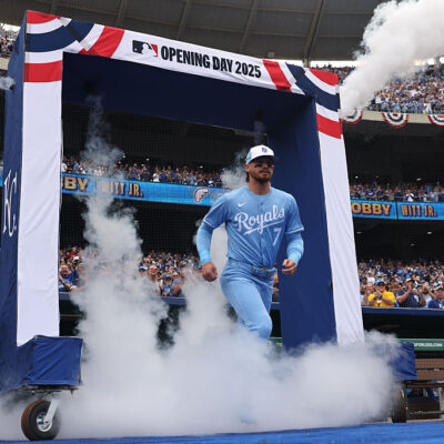 KANSAS CITY, MO - MARCH 27: Kansas City Royals shortstop Bobby Witt Jr. (7) runs through smoke as he is introduced before an Opening Day MLB game between the Cleveland Guardians and Kansas City Royals on March 27, 2025 at Kauffman Stadium in Kansas City, MO. (Photo by Scott Winters/Icon Sportswire via Getty Images)