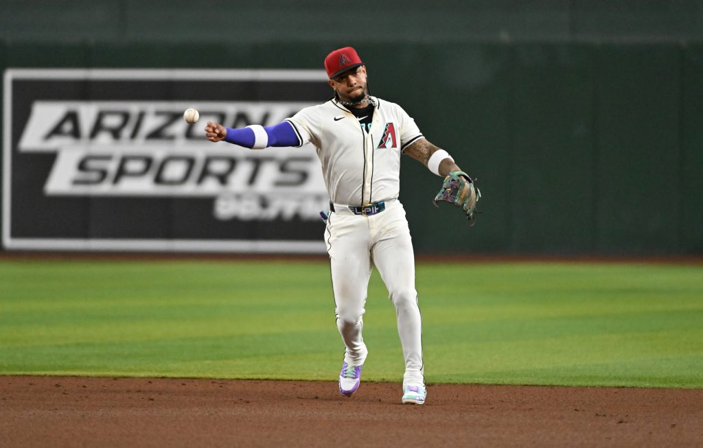 PHOENIX, ARIZONA - MARCH 27: Ketel Marte #4 of the Arizona Diamondbacks throws the ball against the Chicago Cubs at Chase Field on March 27, 2025 in Phoenix, Arizona. (Photo by Norm Hall/Getty Images)