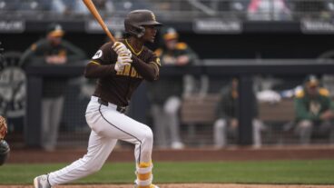 Leodalis De Vries #94 of the San Diego Padres swings and hits the ball during the Spring Breakout Game against the Athletics prospects at Peoria Sports Complex.