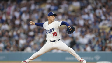 LOS ANGELES, CALIFORNIA - APRIL 11: Yoshinobu Yamamoto #18 of the Los Angeles Dodgers throws against the Chicago Cubs in the first inning at Dodger Stadium on April 11, 2025 in Los Angeles, California. (Photo by Ronald Martinez/Getty Images)