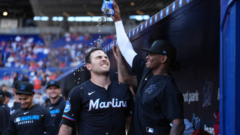 Matt Mervis of the Miami Marlins and Edward Cabrera #27 of the Miami Marlins celebrate in the game against the Washington Nationals at loanDepot park.
