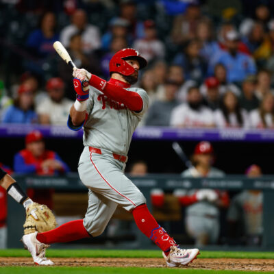 DENVER, CO - MAY 19: Kyle Schwarber #12 of the Philadelphia Phillies follows through on a solo home run in the ninth inning against the Colorado Rockies at Coors Field on May 19, 2025 in Denver, Colorado. The home run is Schwarber's 300th of his career. (Photo by Justin Edmonds/Getty Images)