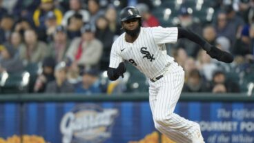 Luis Robert Jr of the Chicago White Sox steals second base in a game against the Milwaukee Brewers at Rate Field.