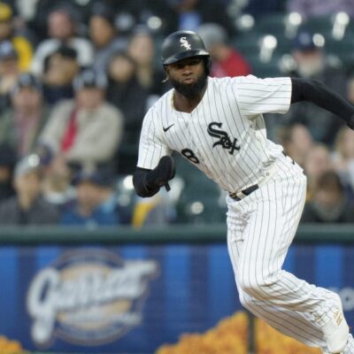 Luis Robert Jr of the Chicago White Sox steals second base in a game against the Milwaukee Brewers at Rate Field.