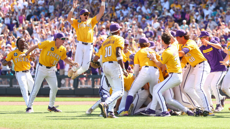 OMAHA, NEBRASKA - JUNE 22: Jake Brown #7 of the LSU Tigers leaps onto the dogpile in celebration after defeating the Coastal Carolina Chanticleers in game two of the Division I Baseball Championship held at Charles Schwab Field on June 22, 2025 in Omaha, Nebraska. (Photo by Tyler McFarland/NCAA Photos via Getty Images)