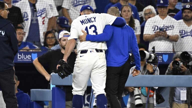 Los Angeles, CA - July 02: Third baseman Max Muncy #13 of the Los Angeles Dodgers is helped off the field after colliding with Michael A. Taylor (not pictured) of the Chicago White Sox as he was tagged out on a attempted steal of third base in the sixth inning during a baseball game at Dodger Stadium in Los Angeles on Wednesday, July 2, 2025.(Photo by Keith Birmingham/MediaNews Group/Pasadena Star-News via Getty Images)