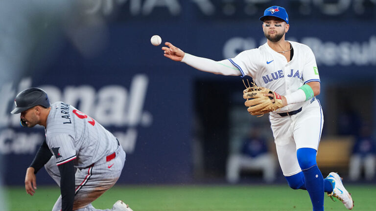 TORONTO, ON - AUGUST 25: Bo Bichette #11 of the Toronto Blue Jays throws to first after tagging out Trevor Larnach #9 of the Minnesota Twins at second in the eighth inning during the game between the Minnesota Twins and the Toronto Blue Jays at Rogers Centre on Monday, August 25, 2025 in Toronto, Ontario, Canada. (Photo by Thomas Skrlj/MLB Photos via Getty Images)