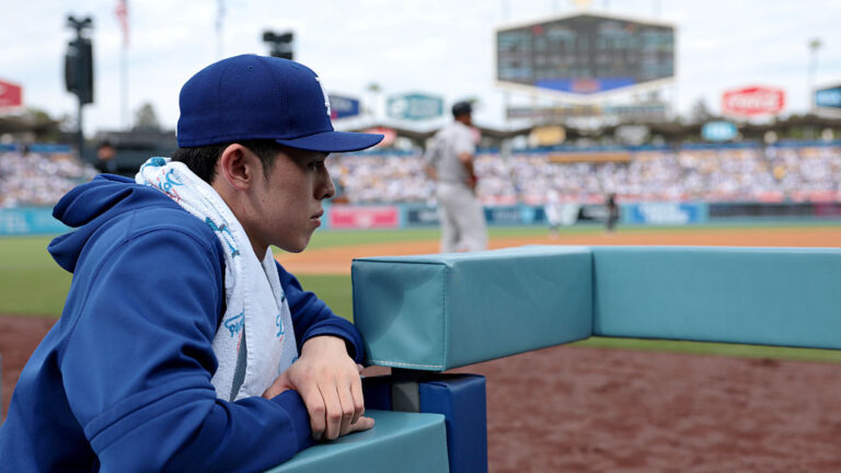 LOS ANGELES, CALIFORNIA - JUNE 01: Roki Sasaki #11 of the Los Angeles Dodgers looks on from the dugout during the second inning against the New York Yankees at Dodger Stadium on June 01, 2025 in Los Angeles, California. (Photo by Katelyn Mulcahy/Getty Images)