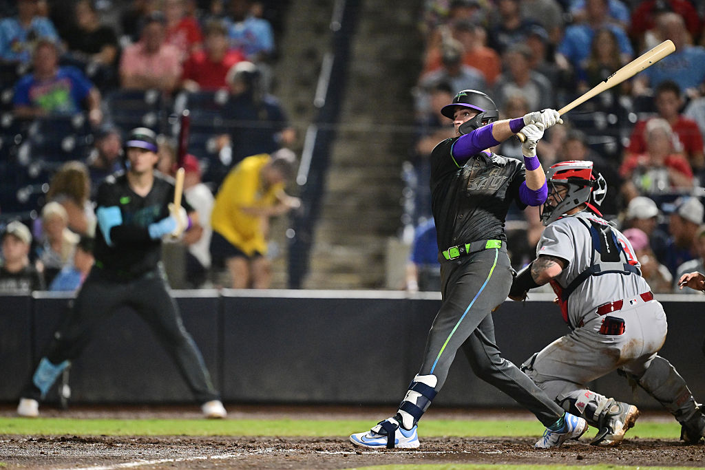 TAMPA, FLORIDA - AUGUST 22: Carson Williams #77 of the Tampa Bay Rays hits a two-run home run in the seventh inning against the St. Louis Cardinals during his Major League Debut at George M. Steinbrenner Field on August 22, 2025 in Tampa, Florida. (Photo by Julio Aguilar/Getty Images)
