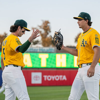 SACRAMENTO, CALIFORNIA - SEPTEMBER 12: Jacob Wilson #5 and Nick Kurtz #16 of the Athletics high five before a game against the Cincinnati Reds at Sutter Health Park on September 12, 2025 in Sacramento, California. (Photo by Justine Willard/Athletics/Getty Images)