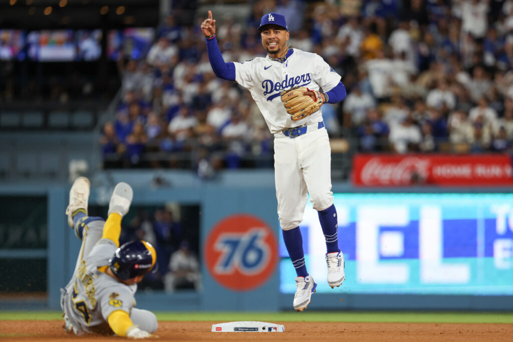 LOS ANGELES, CA - OCTOBER 17: Mookie Betts #50 of the Los Angeles Dodgers turns a double play after tagging out William Contreras #24 of the Milwaukee Brewers in the seventh inning during Game Four of the National League Championship Series presented by loanDepot between the Milwaukee Brewers and the Los Angeles Dodgers at Dodger Stadium on Friday, October 17, 2025 in Los Angeles, California. (Photo by Rob Leiter/MLB Photos via Getty Images)