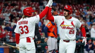 ST LOUIS, MISSOURI - APRIL 14: Brendan Donovan #33 congratulates Nolan Arenado #28 of the St. Louis Cardinals after Arenado hit a solo home run during the seventh inning against the Houston Astros at Busch Stadium on April 14, 2025 in St Louis, Missouri. (Photo by Scott Kane/Getty Images)