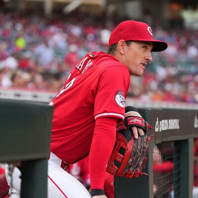 CINCINNATI, OHIO - SEPTEMBER 20: Austin Hays #12 of the Cincinnati Reds stands in the dugout prior to a baseball game against the Chicago Cubs at Great American Ball Park on September 20, 2025 in Cincinnati, Ohio. (Photo by Jeff Dean/Getty Images)