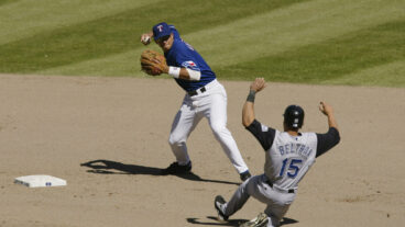 ARLINGTON-JUNE 2: Carlos Beltran #15 of the Kansas City Royals slides into third base as Alex Rodriguez #3 of the Texas Rangers throws to second base during the game against the Texas Rangers at The Ballpark in Arlington, Texas on June 2, 2002. The Rangers won 8-6. (Photo by Ronald Martinez/Getty Images)