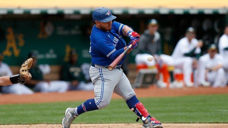 Alejandro Kirk of the Toronto Blue Jays hits a single in the top of the fourth inning against the Oakland Athletics at RingCentral Coliseum.