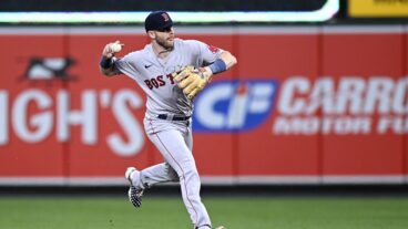 Trevor Story of the Boston Red Sox throws the ball to first base against the Baltimore Orioles at Oriole Park.